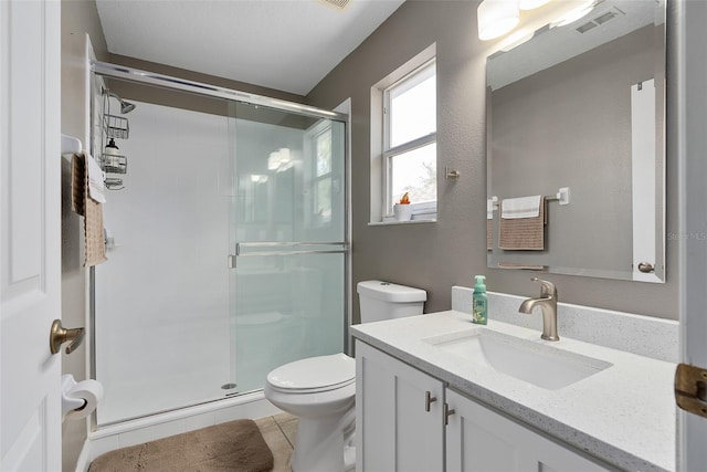 bathroom with an enclosed shower, vanity, and tile patterned floors