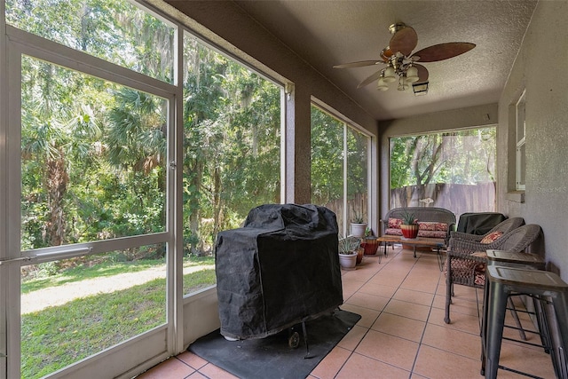 sunroom / solarium featuring ceiling fan