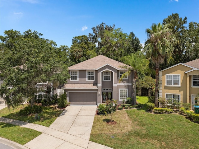 view of front of home with a garage and a front lawn