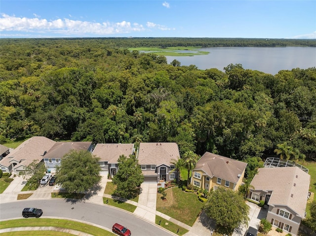 bird's eye view featuring a forest view, a water view, and a residential view