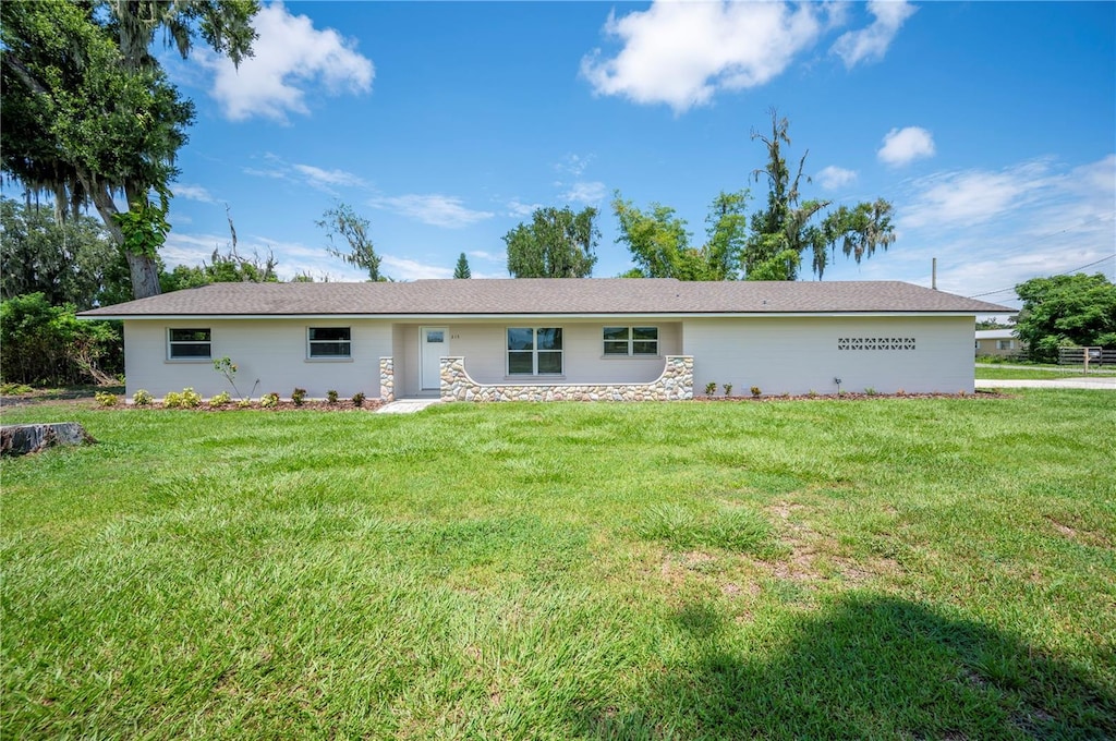 back of property featuring a yard