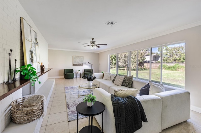 tiled living room with ceiling fan, a healthy amount of sunlight, and ornamental molding