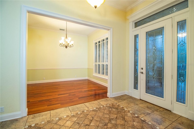 foyer with wood-type flooring, a chandelier, and ornamental molding