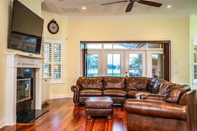 living room with ceiling fan, dark hardwood / wood-style flooring, and crown molding