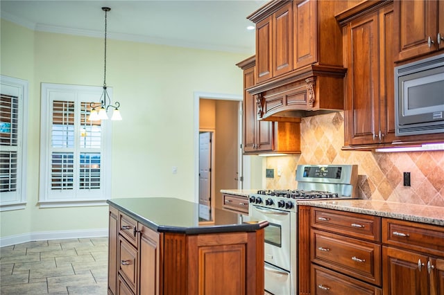 kitchen with pendant lighting, appliances with stainless steel finishes, tasteful backsplash, a center island, and ornamental molding