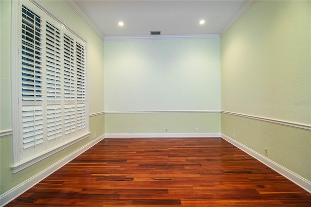 spare room with ornamental molding and hardwood / wood-style floors