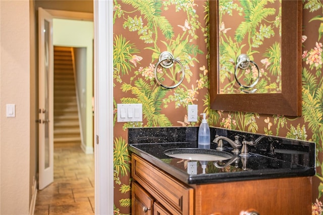 kitchen featuring dark stone counters and sink