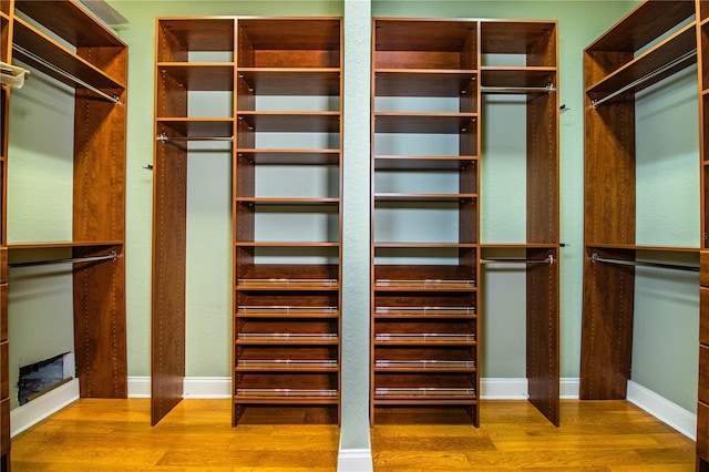 walk in closet with wood-type flooring