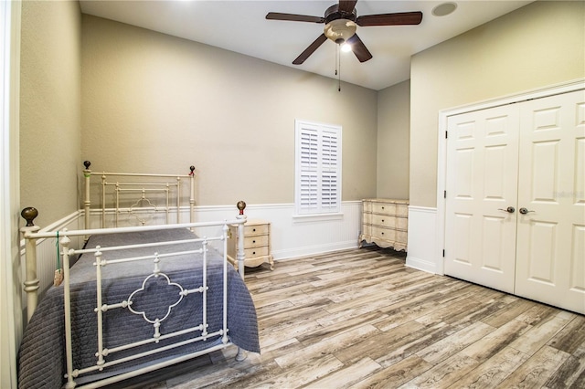 bedroom with a closet, wood-type flooring, and ceiling fan