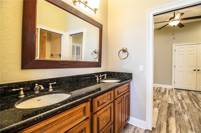 bathroom with ceiling fan, hardwood / wood-style flooring, and vanity