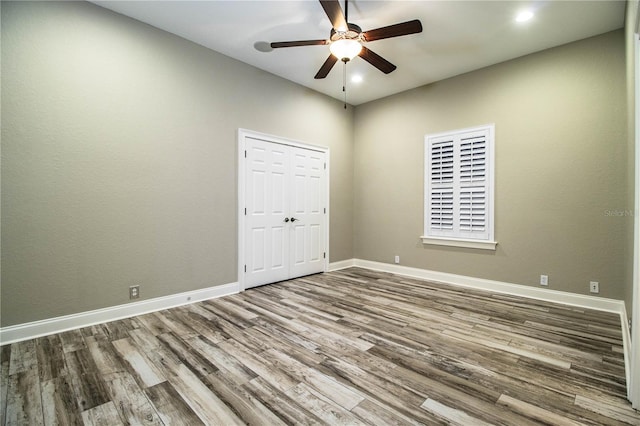 unfurnished room featuring ceiling fan and hardwood / wood-style floors