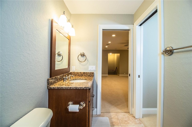 bathroom featuring vanity, toilet, and tile patterned floors