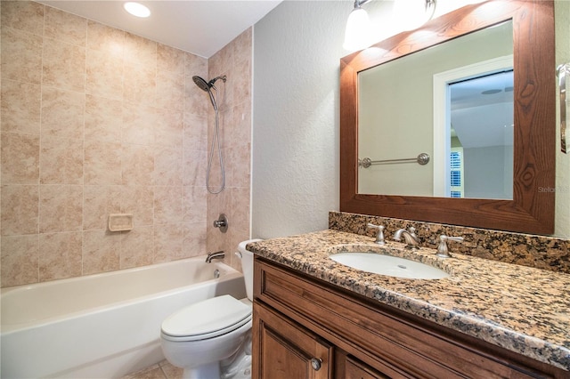 full bathroom with toilet, tiled shower / bath combo, and vanity