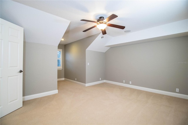 additional living space with ceiling fan, light carpet, and vaulted ceiling