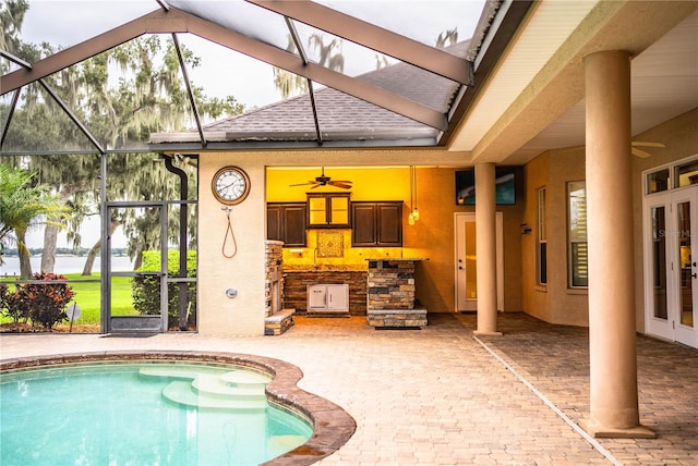 view of pool featuring ceiling fan, a lanai, and a patio area