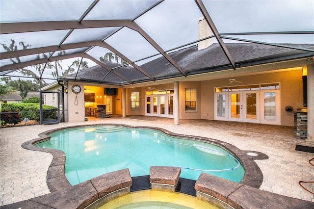 view of pool with french doors, a lanai, a patio area, and ceiling fan