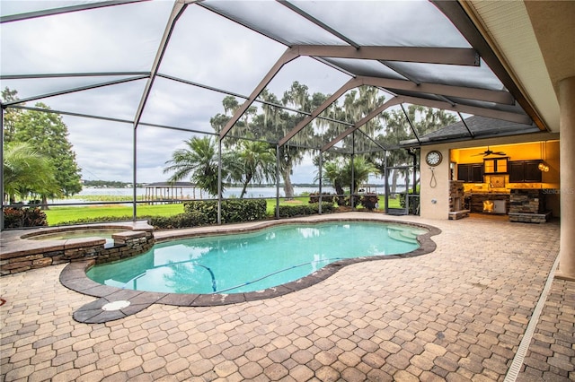 view of pool featuring a water view, glass enclosure, a patio area, and an in ground hot tub