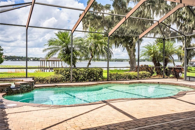 view of pool featuring a water view, pool water feature, a patio, and glass enclosure