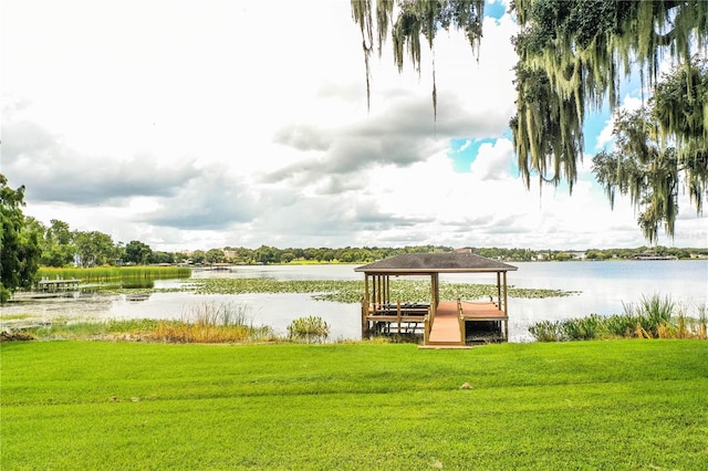 view of dock featuring a water view and a lawn