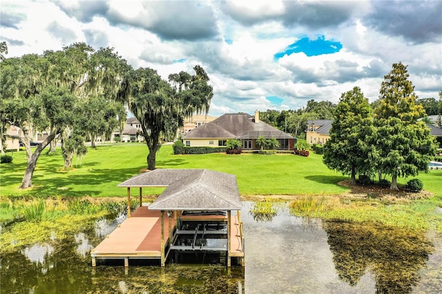 dock area featuring a water view and a lawn