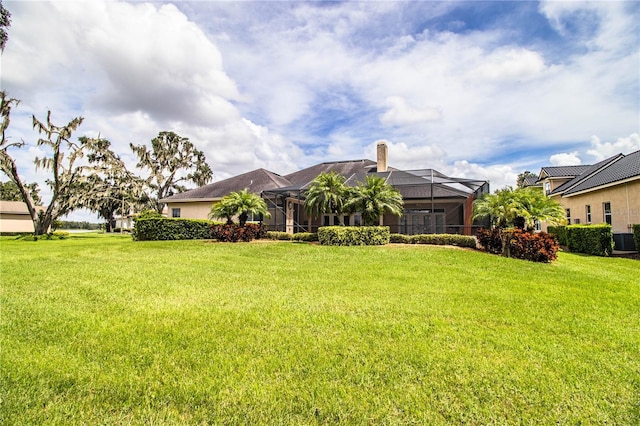 view of front of house featuring a lanai and a front yard