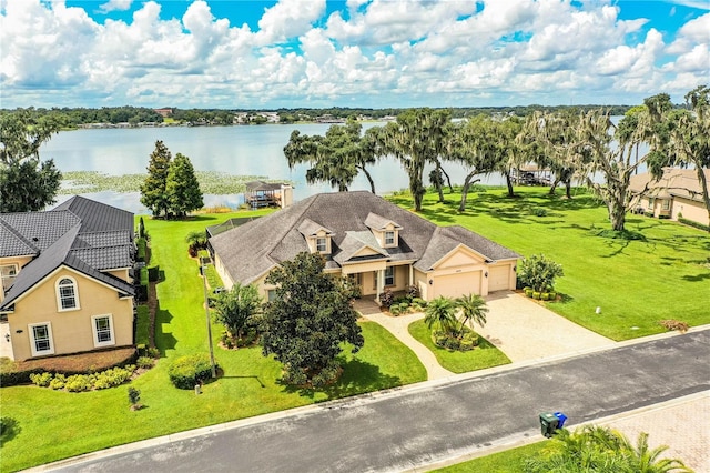 birds eye view of property with a water view