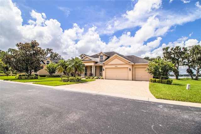 view of front of property with a garage and a front yard