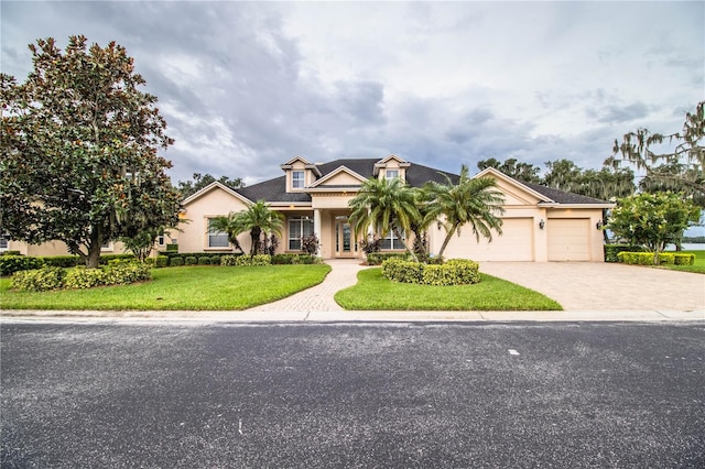 view of front of property with a front yard and a garage