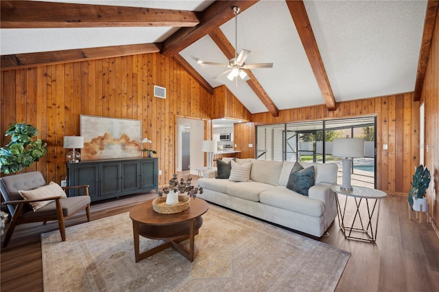 4500 Old Colony Rd, Mulberry, FL 33860 - living room with wooden walls, wood finished floors, and a ceiling fan