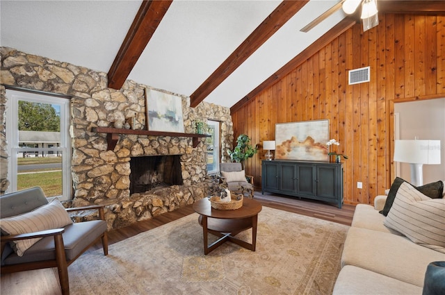 4500 Old Colony Rd, Mulberry, FL 33860 - living room featuring wood finished floors, beamed ceiling, wood walls, high vaulted ceiling, and a fireplace
