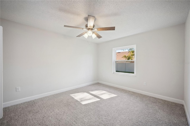 carpeted spare room with ceiling fan and a textured ceiling