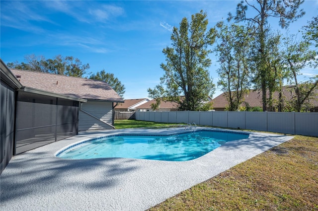 view of pool featuring a lawn