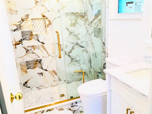 bathroom featuring a shower with door, vanity, and toilet