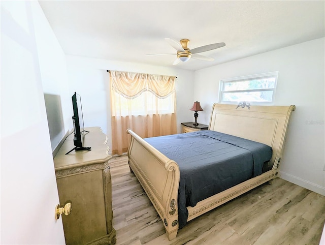 bedroom with ceiling fan and light hardwood / wood-style flooring