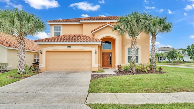 mediterranean / spanish house with stucco siding, an attached garage, a front yard, driveway, and a tiled roof