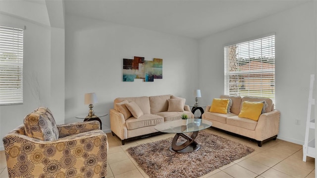 living area with light tile patterned floors and baseboards