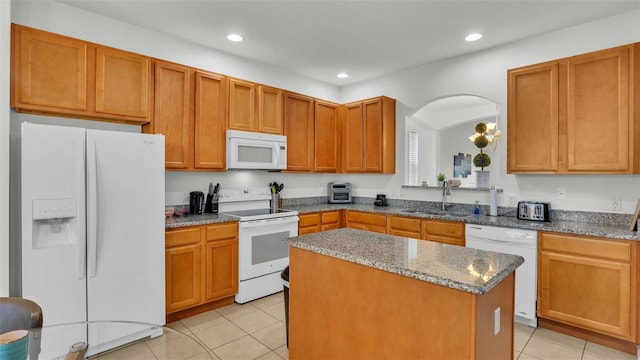 kitchen with white appliances, light tile patterned floors, a kitchen island, a sink, and recessed lighting