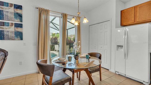 dining space featuring a chandelier, baseboards, and light tile patterned floors