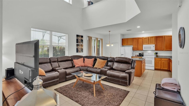 living area with a high ceiling, light tile patterned flooring, and recessed lighting