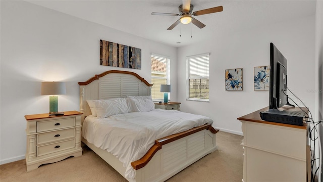 bedroom featuring ceiling fan, baseboards, and light colored carpet