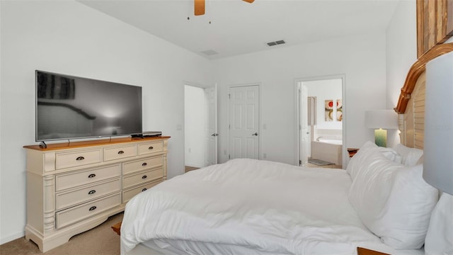 bedroom featuring light carpet, baseboards, visible vents, connected bathroom, and ceiling fan