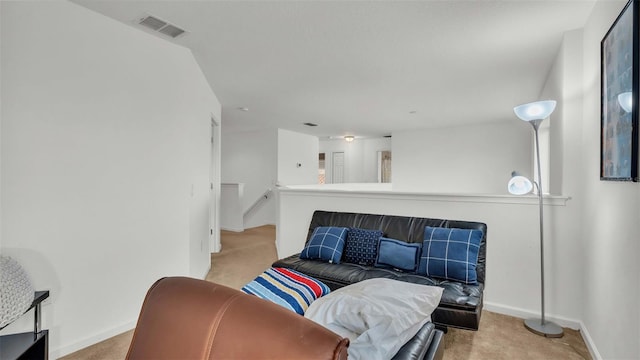 carpeted living area featuring baseboards and visible vents