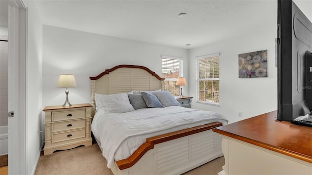 bedroom featuring light colored carpet