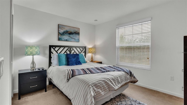 carpeted bedroom featuring baseboards