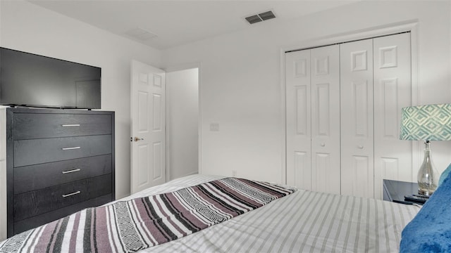 bedroom with a closet and visible vents