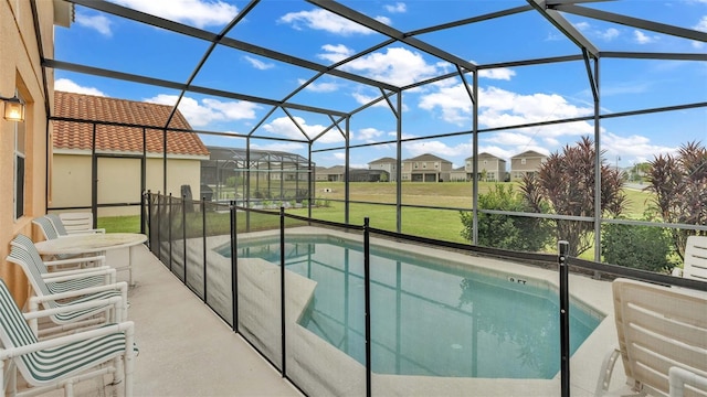 pool featuring a residential view, a lanai, a lawn, and a patio