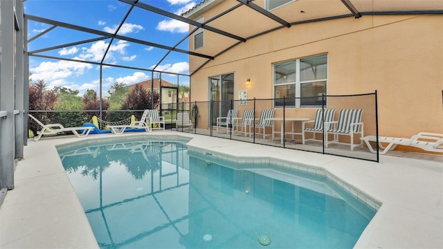 outdoor pool featuring a lanai and a patio