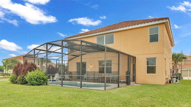 back of property featuring glass enclosure, a patio, a lawn, an outdoor pool, and stucco siding