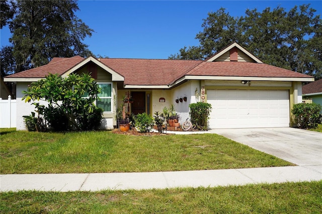 ranch-style house featuring stucco siding, a front yard, fence, a garage, and driveway