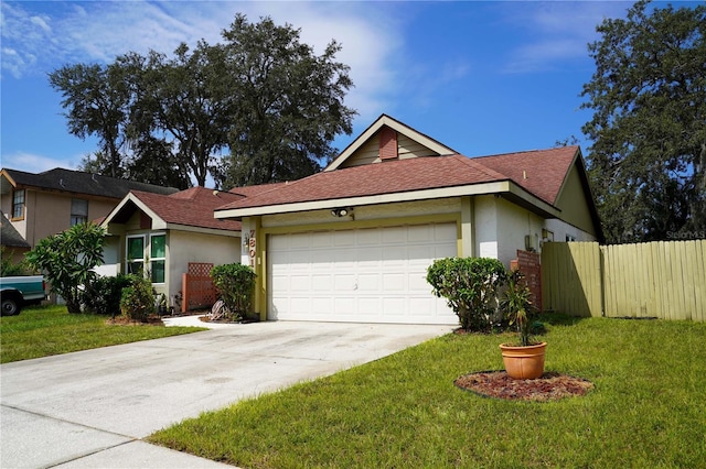 ranch-style home with a garage, a front lawn, fence, and stucco siding